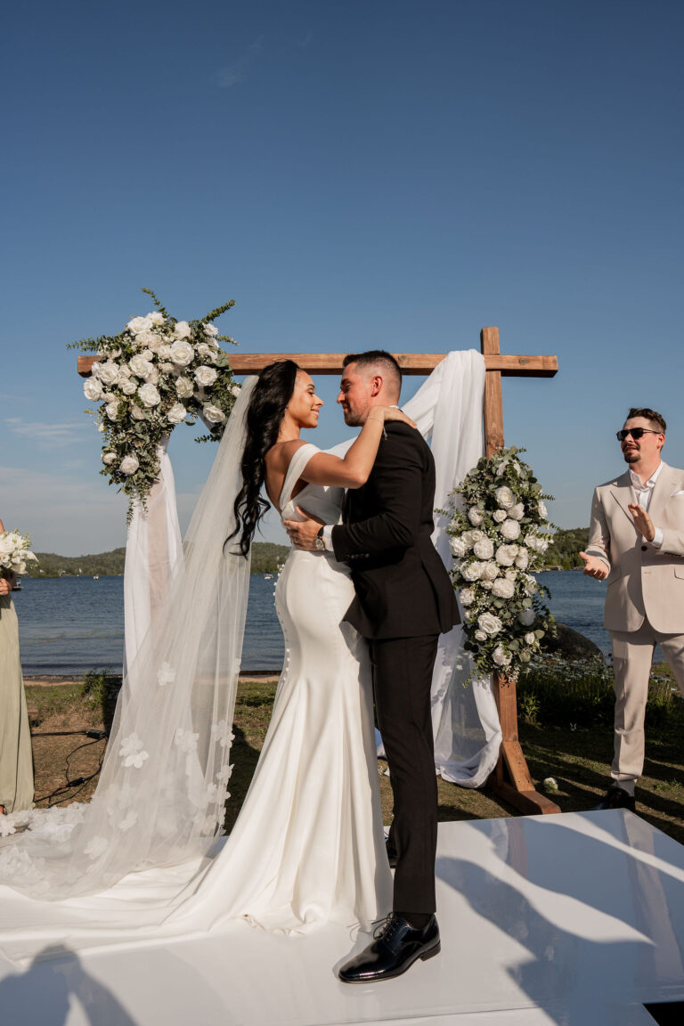 Cérémonie sous une arche fleurie, face au lac